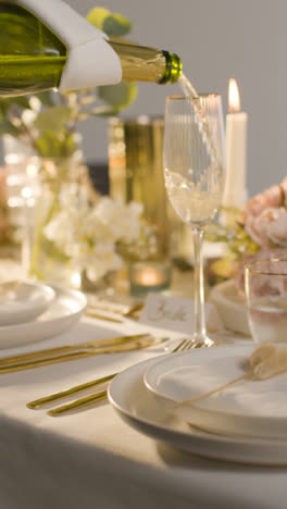 Vertical-Video-Of-Table-Set-For-Meal-At-Wedding-Reception-With-Champagne-And-Place-Card-For-Bride-3